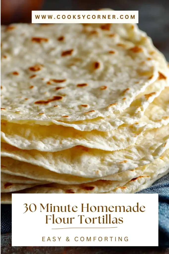 Stack of soft homemade flour tortillas wrapped in a kitchen towel.