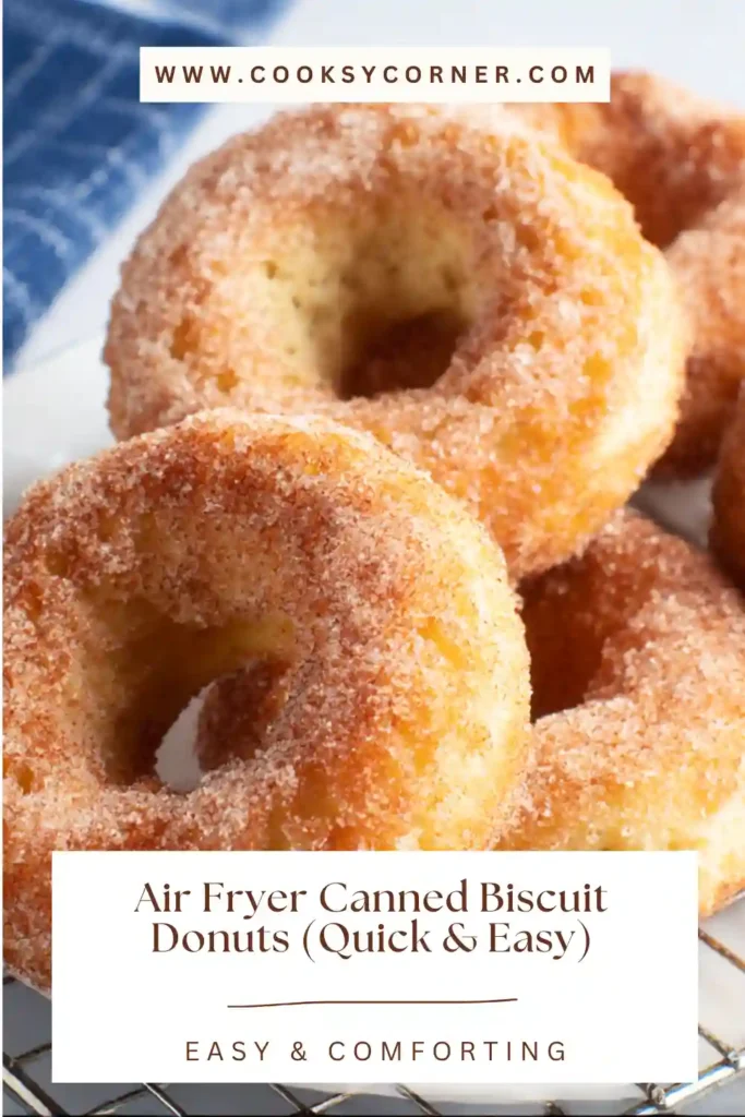 Air Fryer Canned Biscuit Donuts coated in cinnamon sugar and cooling on a wire rack.