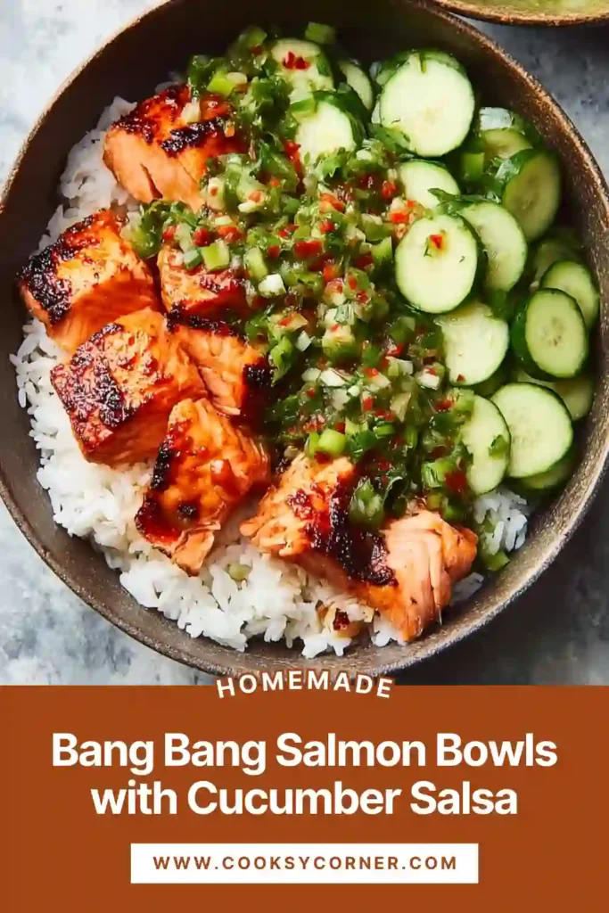 Bang Bang Salmon Bowls served with rice, creamy sauce, avocado, and cucumber salsa in a vibrant bowl. The salmon is golden, tender, and perfectly cooked.