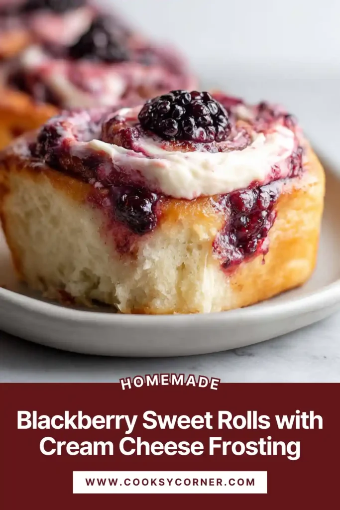 Soft blackberry sweet rolls with cream cheese frosting baked until golden and swirled with berry filling. The rolls look fluffy and rich with visible blackberry layers.