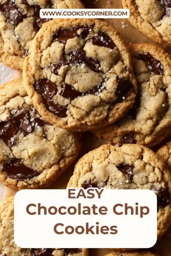 Close-up of chocolate chip cookies bakery style with dark chocolate chunks and flaky sea salt on top. The cookies are thick and soft.