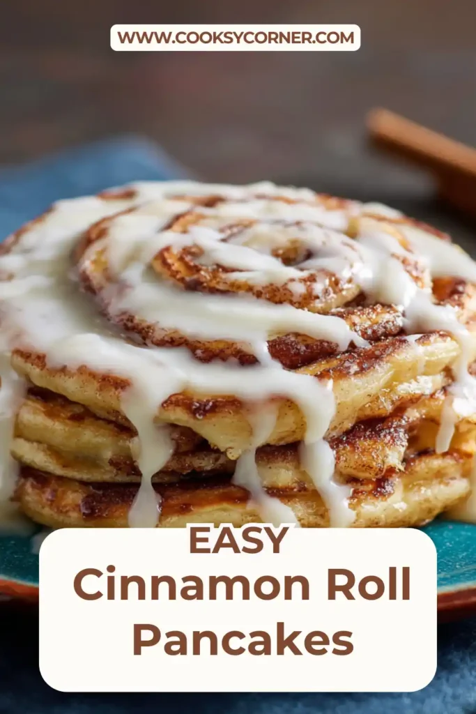 Cinnamon Roll Pancakes stacked on a plate with cinnamon swirl and cream cheese glaze dripping over fluffy layers, served warm for breakfast.