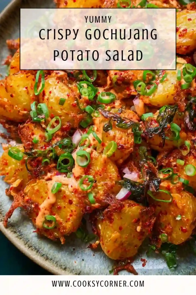 Vegan gochujang potato salad topped with chives and sesame seeds.