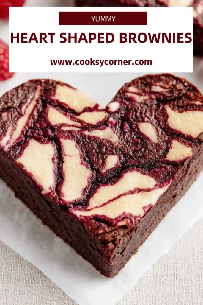 Fudgy chocolate brownies cut into heart shapes with raspberry topping.