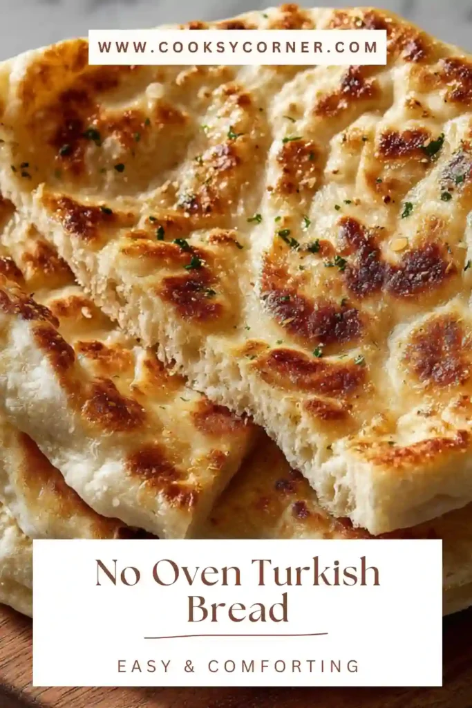 Fresh homemade bazlama bread stacked and brushed with butter. Traditional Turkish flatbread made without an oven.