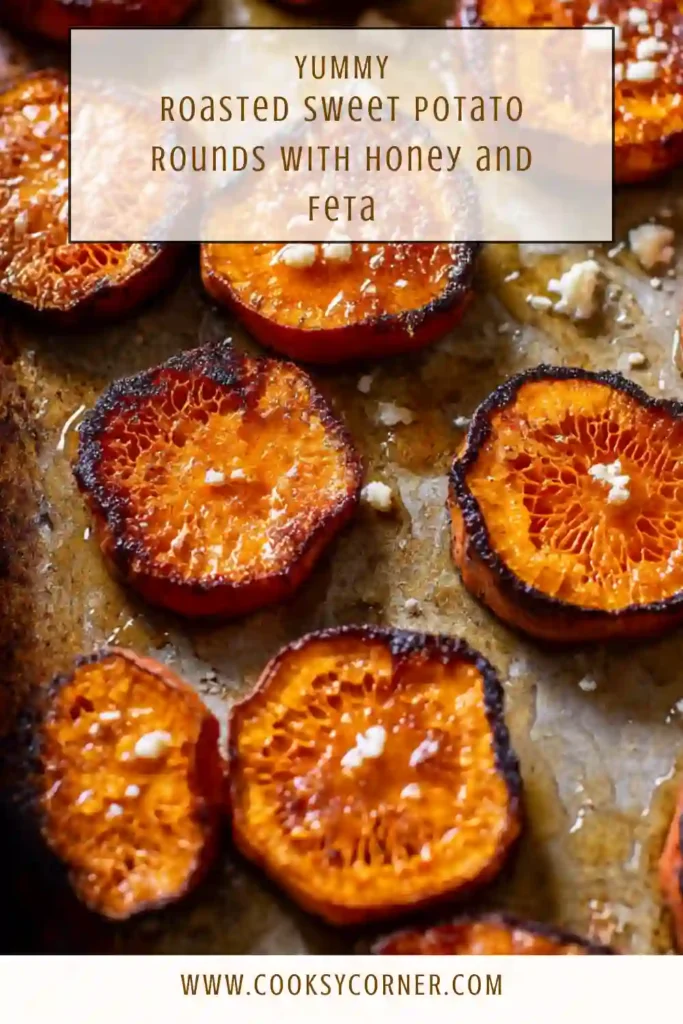 Roasted sweet potato rounds topped with honey, feta cheese, and fresh herbs served warm on a platter.
