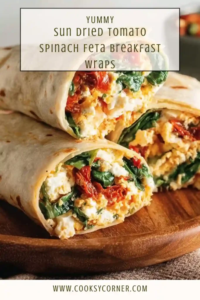 Sun-dried tomato spinach feta breakfast wrap sliced in half, showing egg white filling.