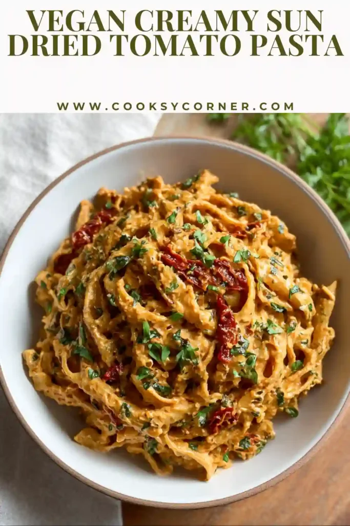Dairy-free creamy sun dried tomato pasta served with parsley and vegan parmesan.