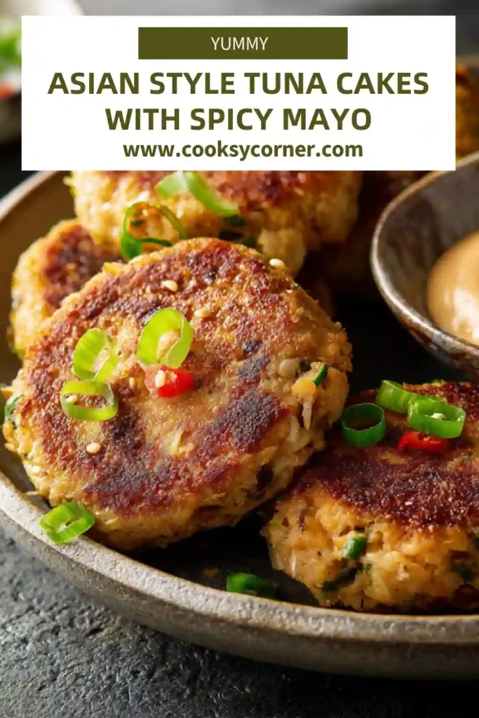 Asian-Style Tuna Cakes with Spicy Mayo served on a plate with dipping sauce and fresh herbs.