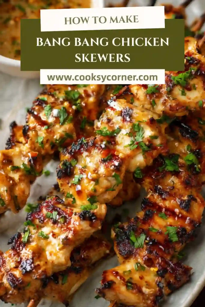 Spicy chicken skewers brushed with bang bang sauce and garnished with green onions.