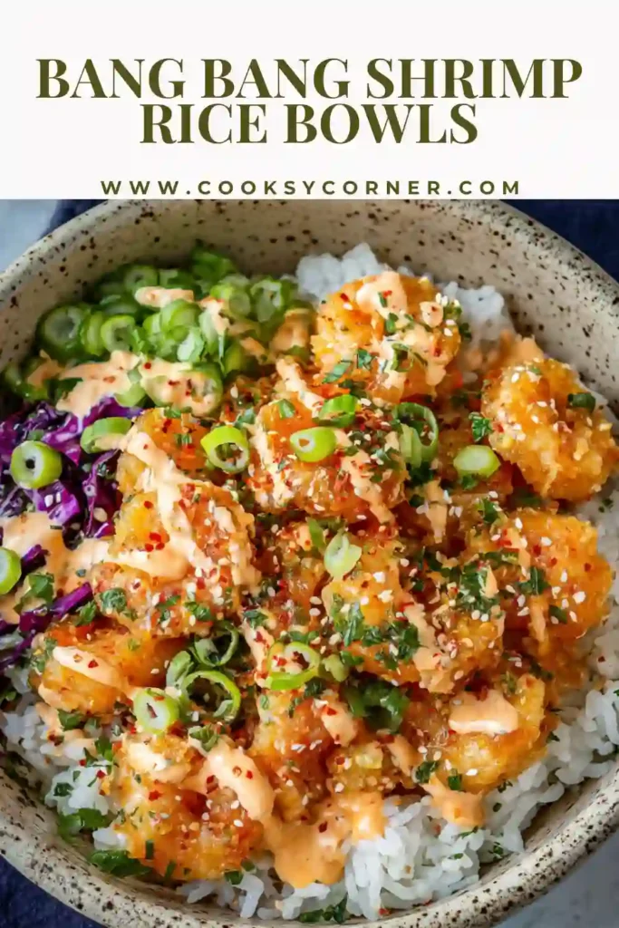 Homemade Bang Bang Shrimp Rice Bowls with crunchy cabbage slaw and creamy drizzle over fluffy rice. The shrimp looks golden, crispy, and flavorful.