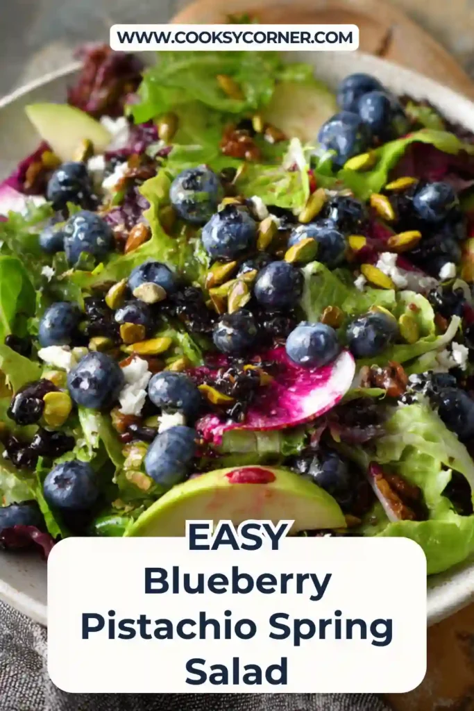 Overhead view of colorful blueberry pistachio salad arranged on a white serving platter.