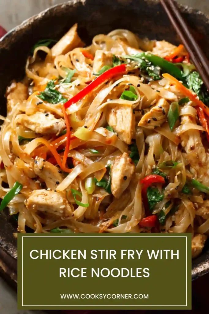 Bowl of chicken stir fry with rice noodles showing tender chicken strips and colorful vegetables.