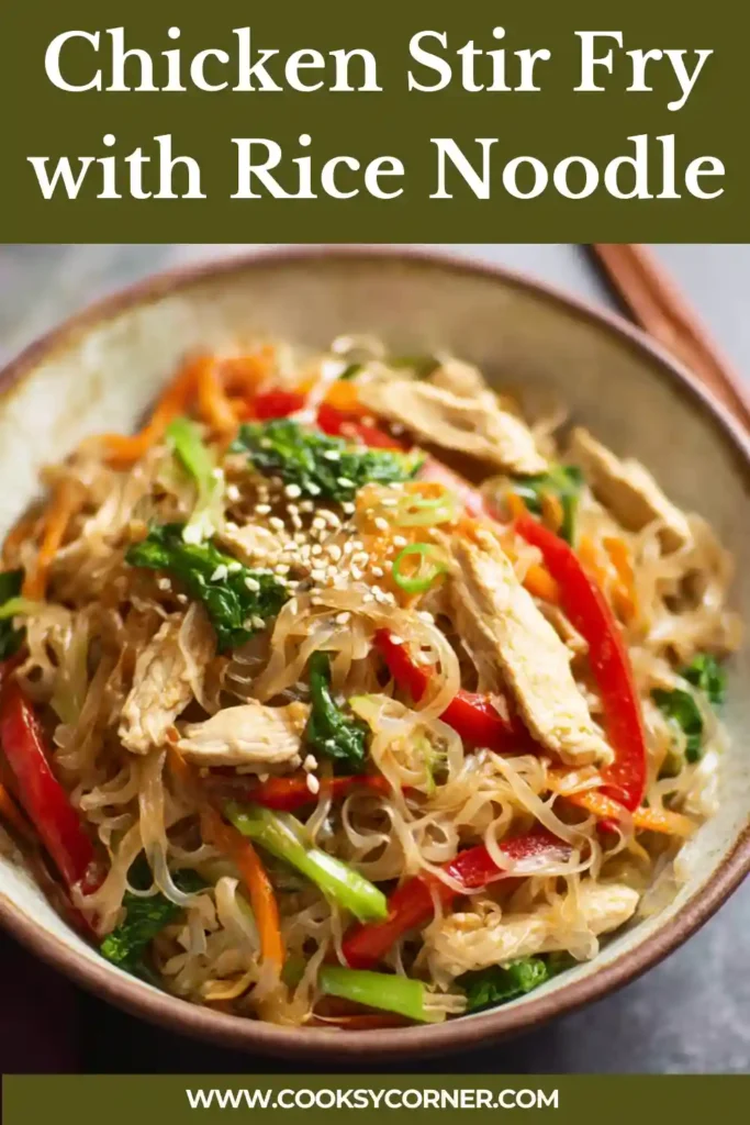 Chicken Stir Fry with Rice Noodles served hot with vegetables and sesame seeds. The noodles are glossy and coated in a savory sauce.
