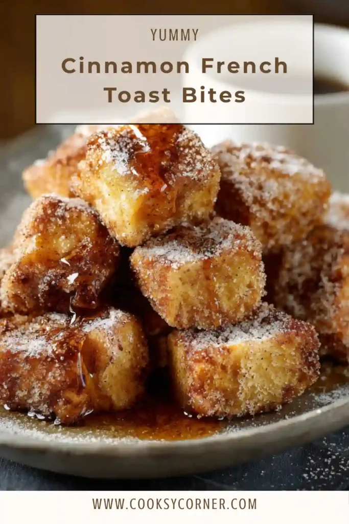 Golden brown Cinnamon French Toast Bites coated in cinnamon sugar served with maple syrup in a small dipping bowl. The bite sized french toast cubes look crispy on the outside and fluffy inside.