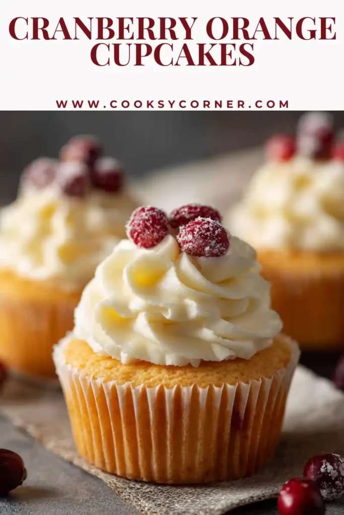 Cranberry Orange Cupcakes topped with cream cheese frosting and fresh cranberries on a dessert table.