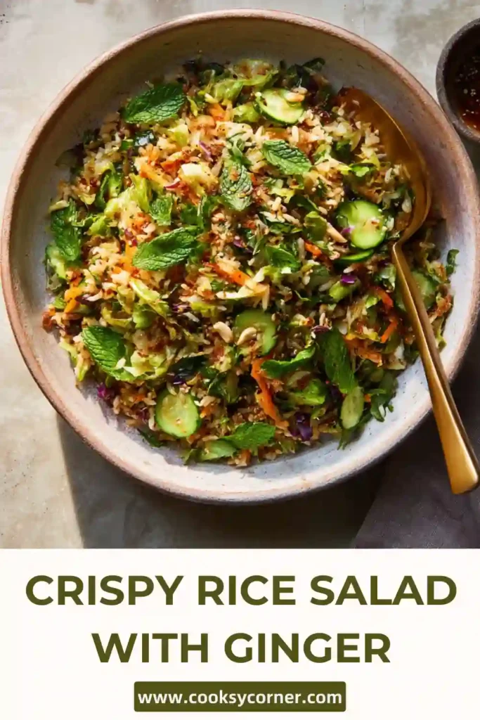 Close-up of crispy baked jasmine rice mixed into a vibrant salad with ginger sesame vinaigrette and creamy avocado.