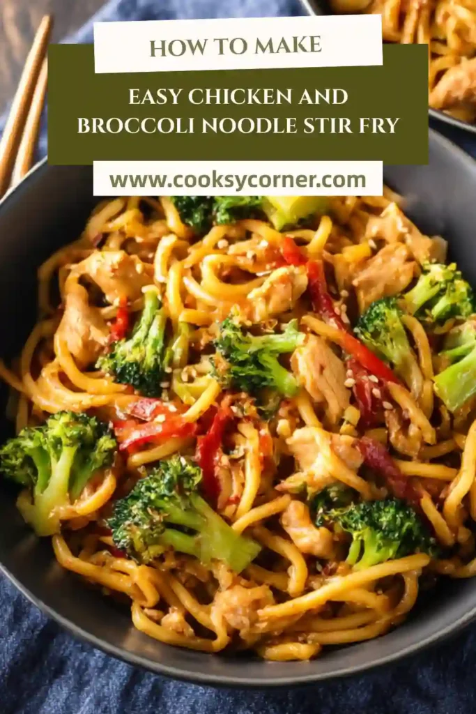 Easy Chicken and Broccoli Noodle Stir Fry served hot in a skillet with udon noodles and sesame seeds. The chicken is tender and coated in a glossy sauce.