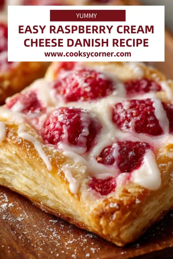Close-up of raspberry cream cheese danish showing flaky layers and smooth cheesecake filling.