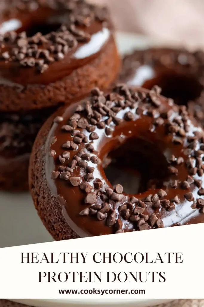 Homemade Healthy Chocolate Protein Donuts arranged on parchment paper with melted chocolate drizzle. Almond flour and cocoa create a rich, fudgy texture.