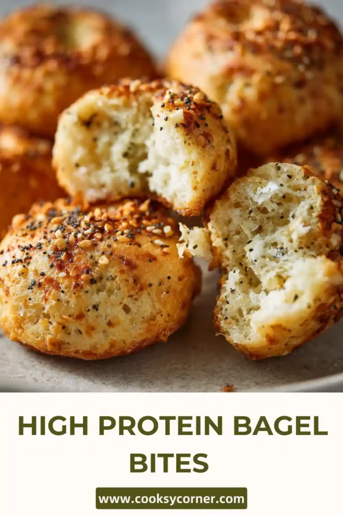 Freshly baked protein bagel bites cooling on a rack with visible seasoning crust.