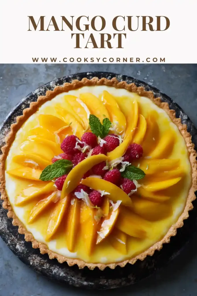 Mango Curd Tart topped with sliced mango, raspberries, cherries, and whipped cream.
