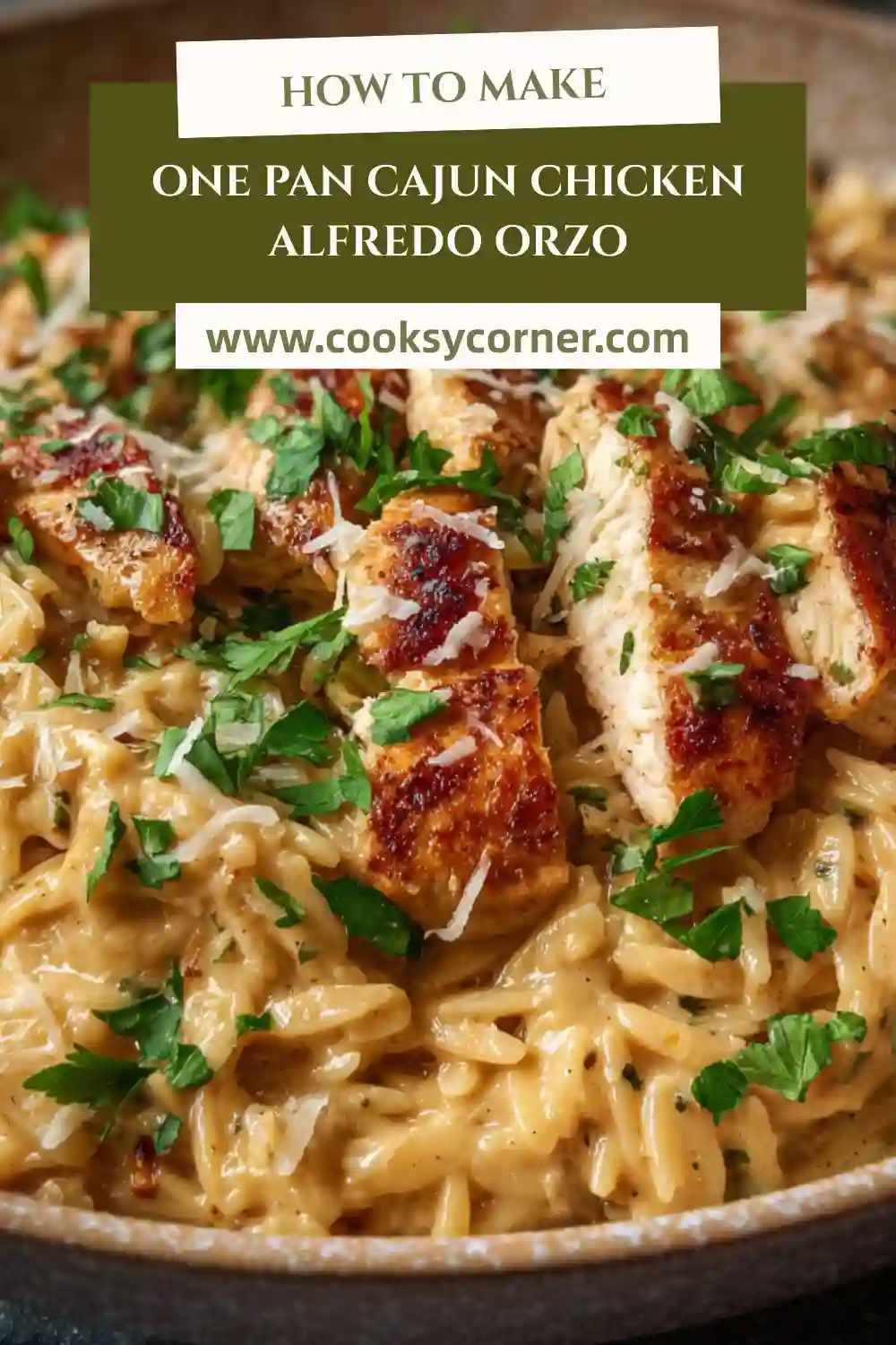 One Pan Cajun Chicken Alfredo Orzo served in a skillet with creamy Parmesan sauce and fresh parsley.
