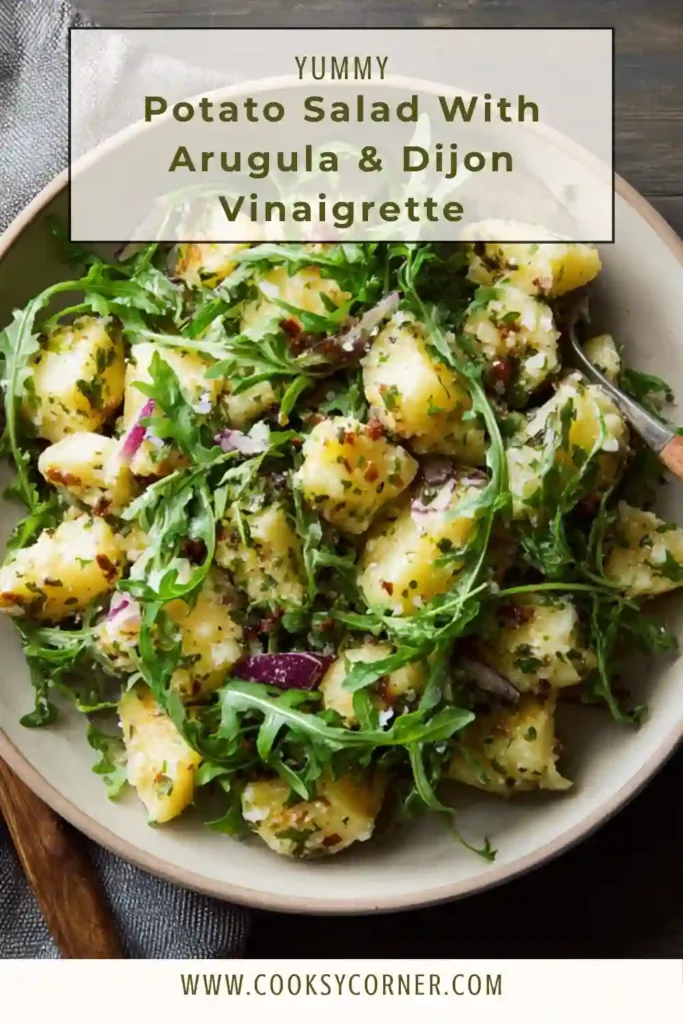 New potatoes tossed with peppery arugula and mustard vinaigrette in a rustic serving dish.