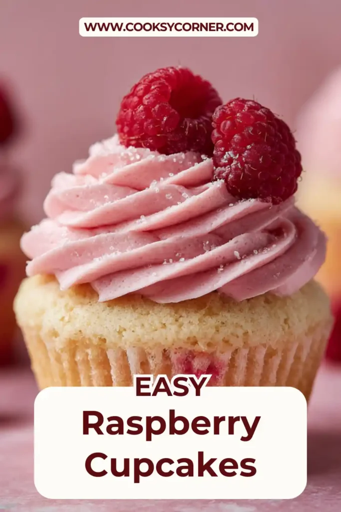 Raspberry cupcakes topped with pink raspberry buttercream and fresh berries.