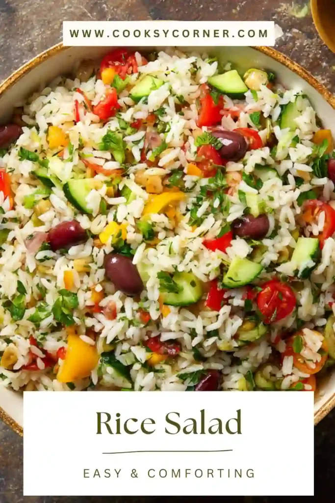 Rice Salad in a large bowl with whole grain rice, cherry tomatoes, cucumber, chickpeas, and fresh herbs. Bright Mediterranean-style salad.
