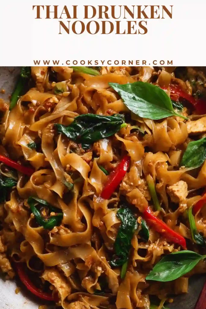 Thai Drunken Noodles served hot with wide rice noodles, basil, and chicken coated in savory sauce. This Pad Kee Mao dish looks glossy, spicy, and freshly stir-fried.
