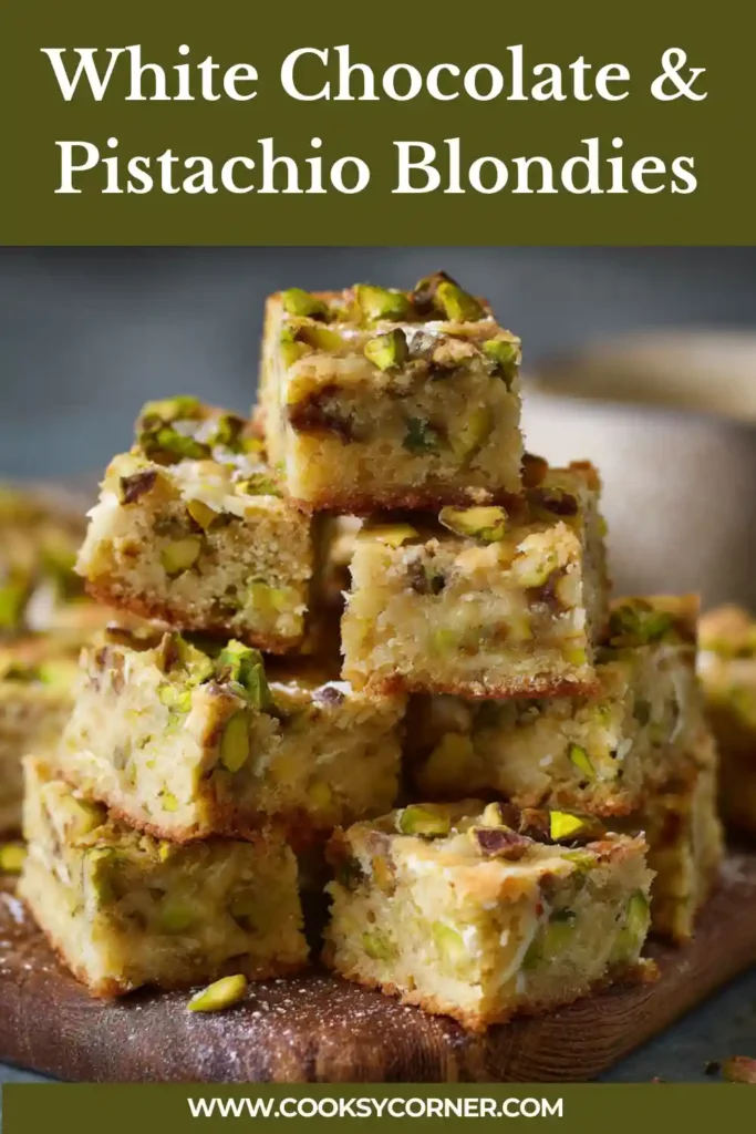 White Chocolate & Pistachio Blondies topped with melted white chocolate and chopped pistachios.