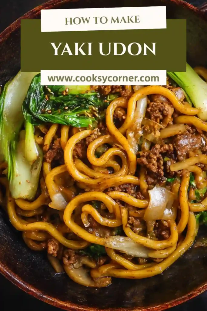 Chewy udon noodles tossed with vegetables and beef in a wok.