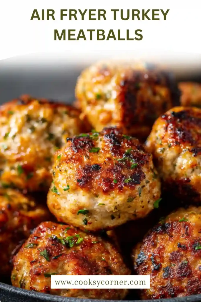 Close-up of healthy turkey meatballs cooked in an air fryer with a crisp exterior and tender inside.