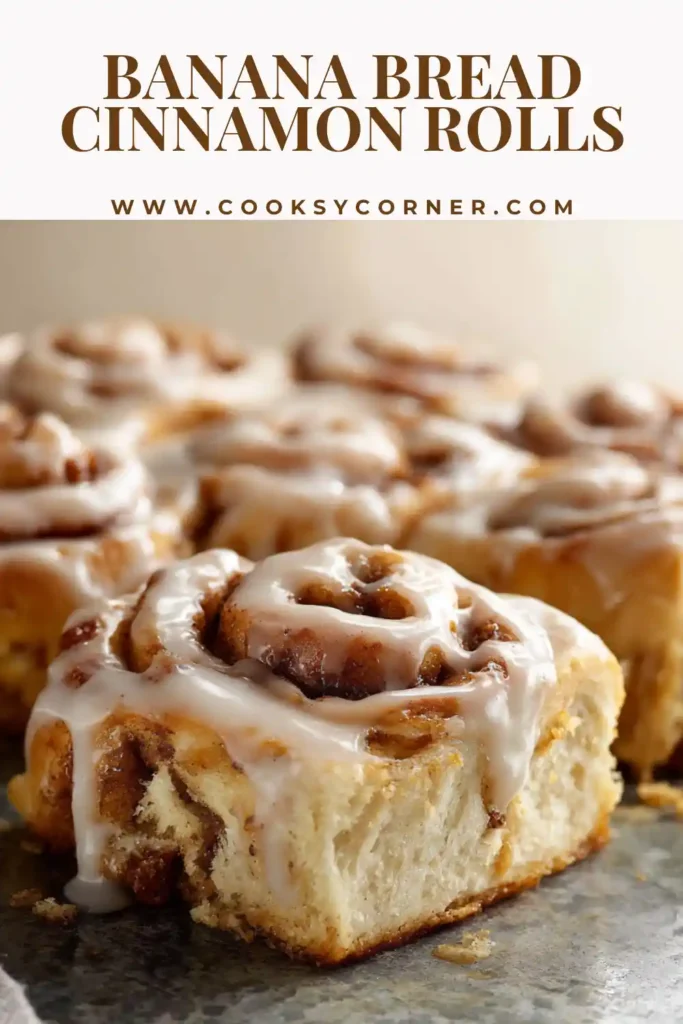 Banana bread cinnamon rolls with cream cheese frosting served warm in a baking dish.