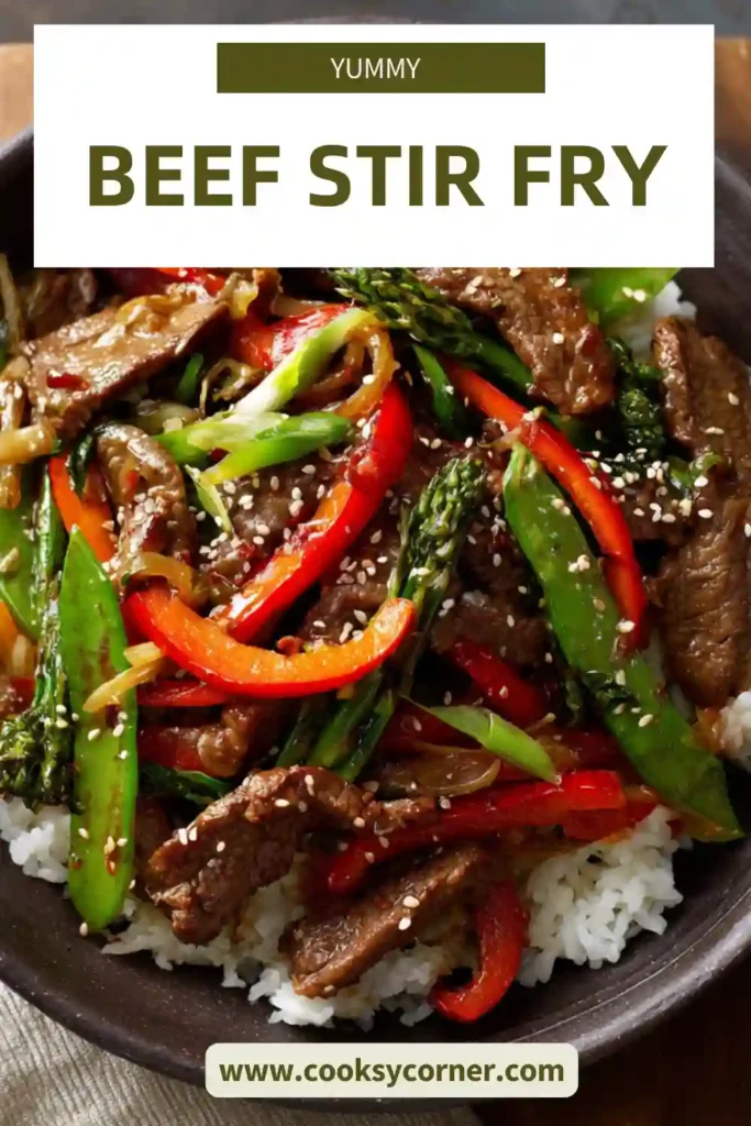 A bowl of beef stir-fry with tender beef strips, bell peppers, snap peas, and carrots served over rice with glossy stir-fry sauce.
