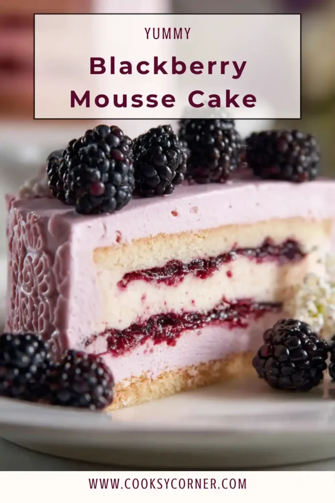Blackberry mousse cake layered with blackberry buttercream and fresh berries.