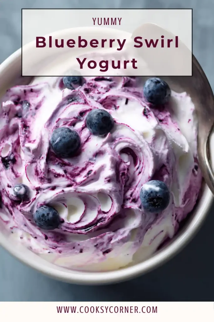 Thick blueberry compote swirled into creamy yogurt in a glass bowl.