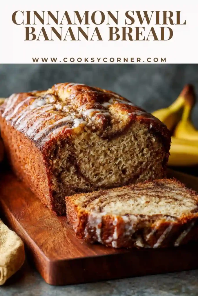 Cinnamon swirl banana bread sliced to show cinnamon sugar layers and drizzled with vanilla icing.