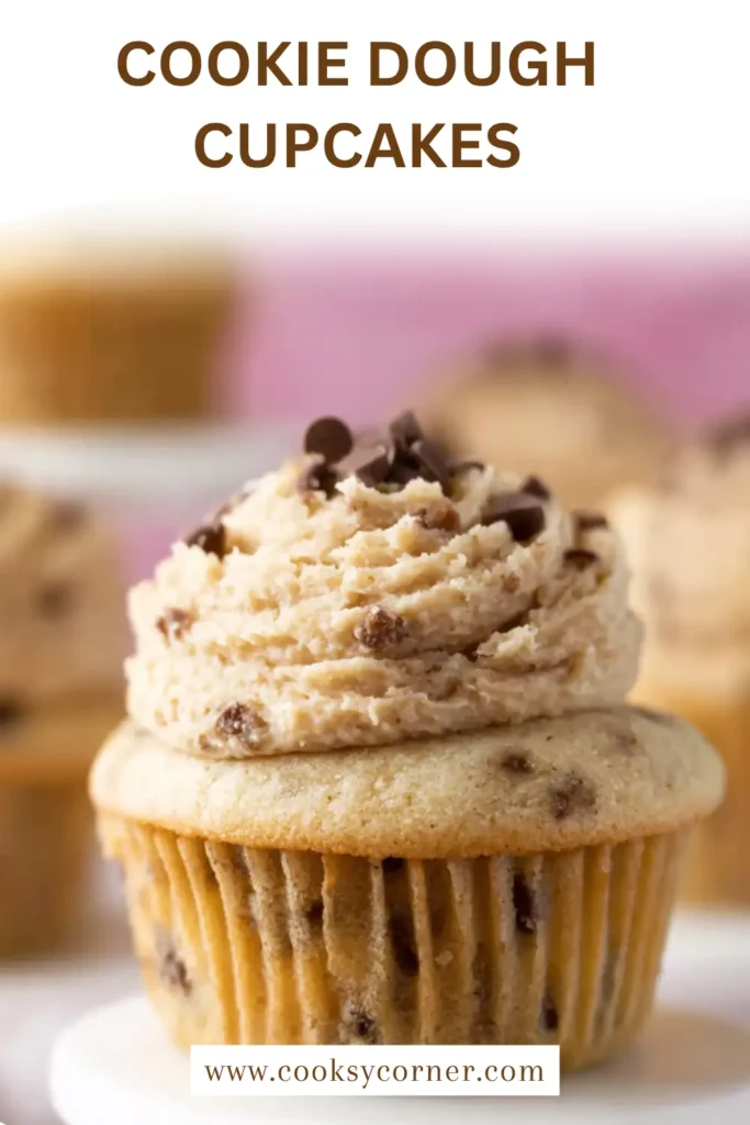 Soft cookie dough cupcakes filled with edible cookie dough and topped with brown sugar buttercream frosting on a cooling rack.