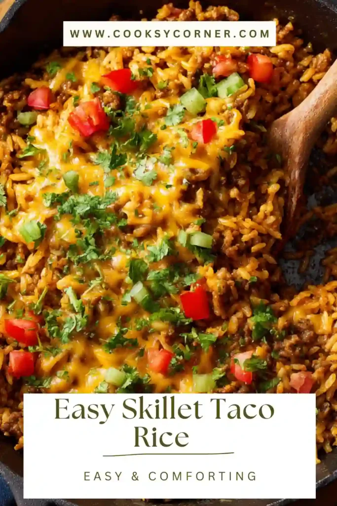 Easy skillet taco rice served in a pan with melted cheese, ground beef, and fresh cilantro on top.
