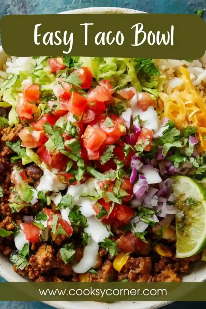 Healthy easy taco bowl topped with cilantro, cheddar cheese, and vibrant vegetables.