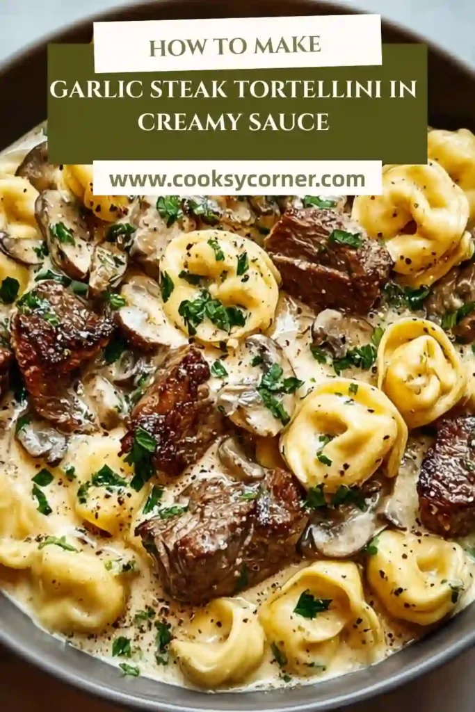 Homemade garlic steak tortellini plated with creamy sauce and sprinkled with black pepper and herbs.