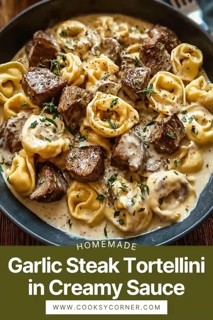 Creamy garlic steak tortellini served in a skillet with melted cheese sauce and fresh parsley garnish.