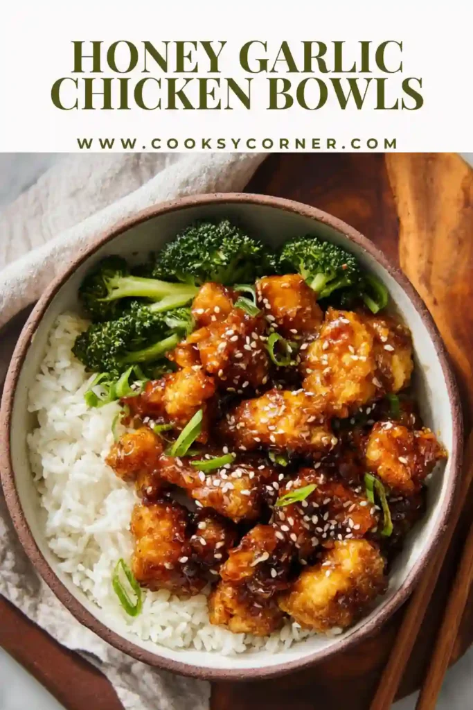 Baked honey garlic chicken pieces tossed in sticky sauce served in a rice bowl with green broccoli. Perfect weeknight dinner idea.