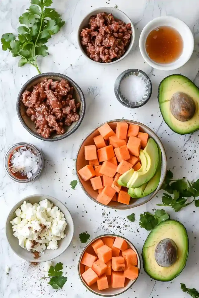 Balanced high-protein hot honey ground beef bowl with avocado, cottage cheese, roasted sweet potatoes, and savory ground beef.