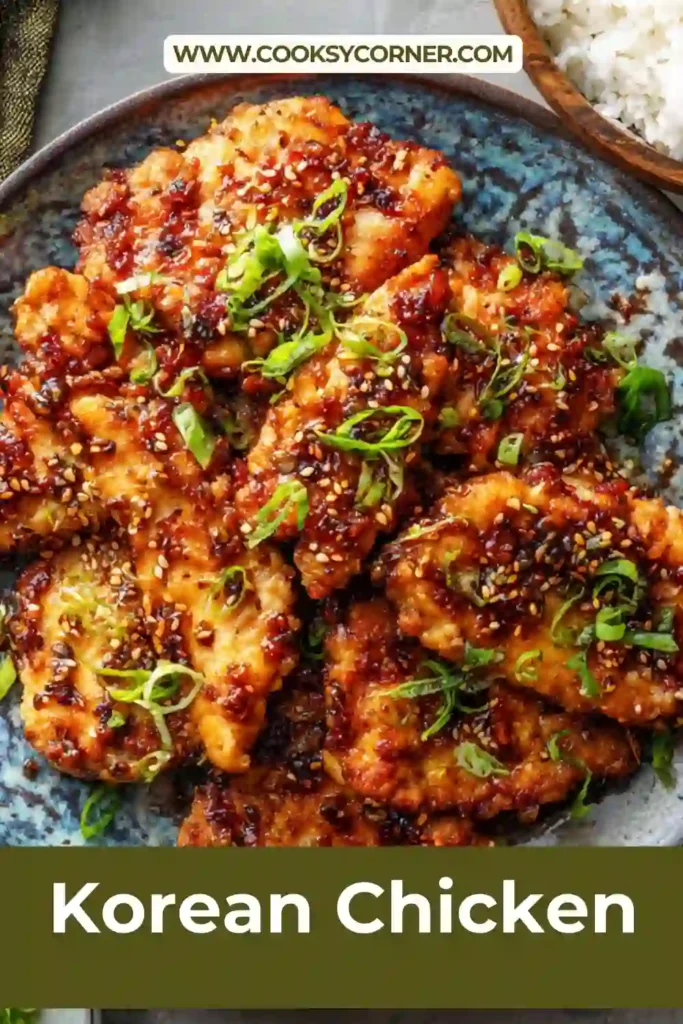 Korean BBQ chicken served over rice with sesame seeds and green onions. The chicken appears juicy and golden brown.