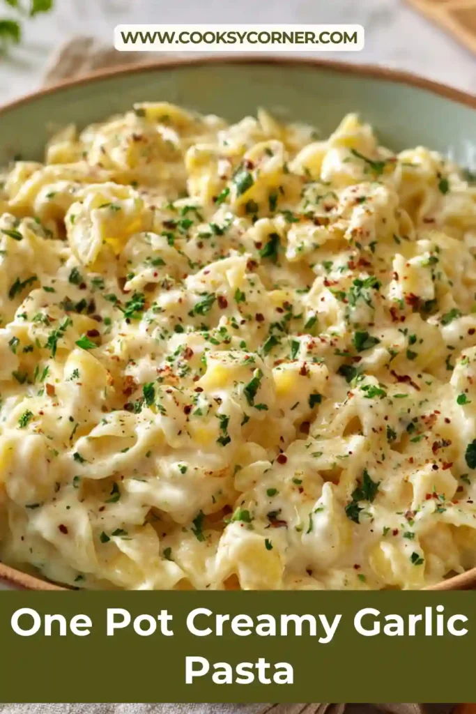 Creamy garlic pasta served in a bowl with parmesan cheese and fresh parsley garnish.