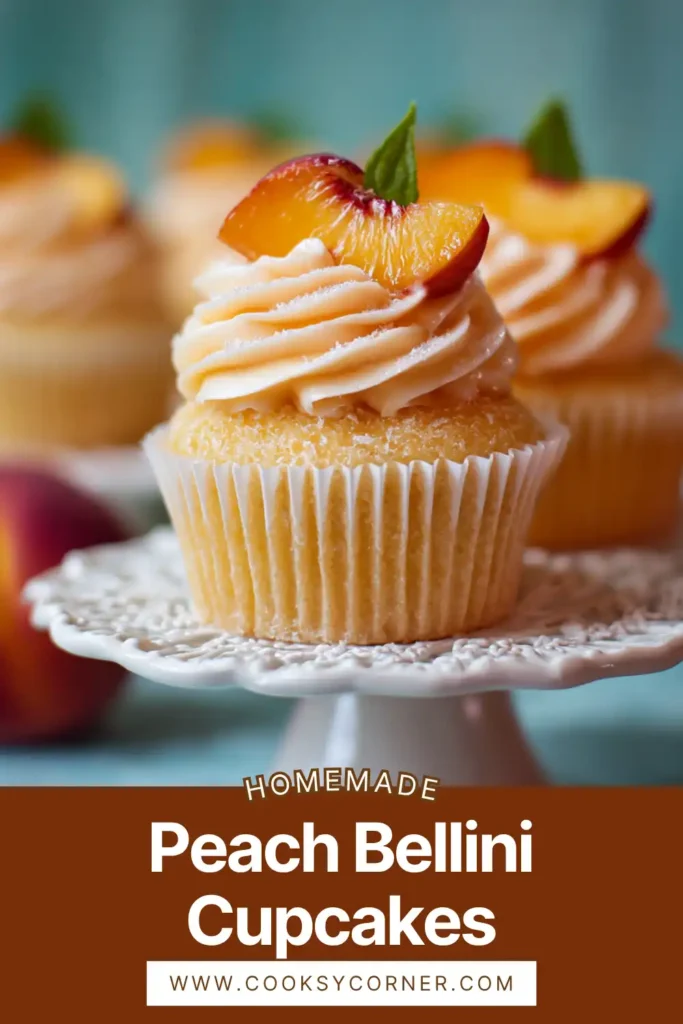 Peach Bellini cupcakes with creamy peach frosting and fresh peach slices on top.