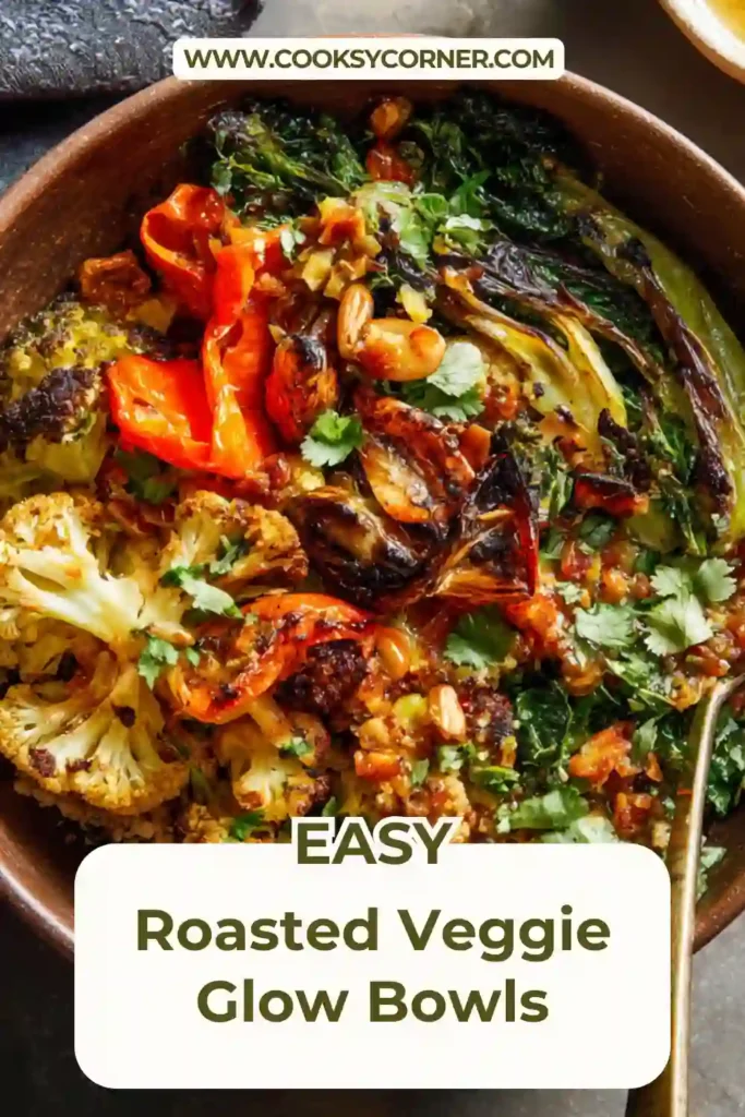 Roasted veggie glow bowl with quinoa, roasted cauliflower, carrots, kale, avocado slices, and tahini dressing.